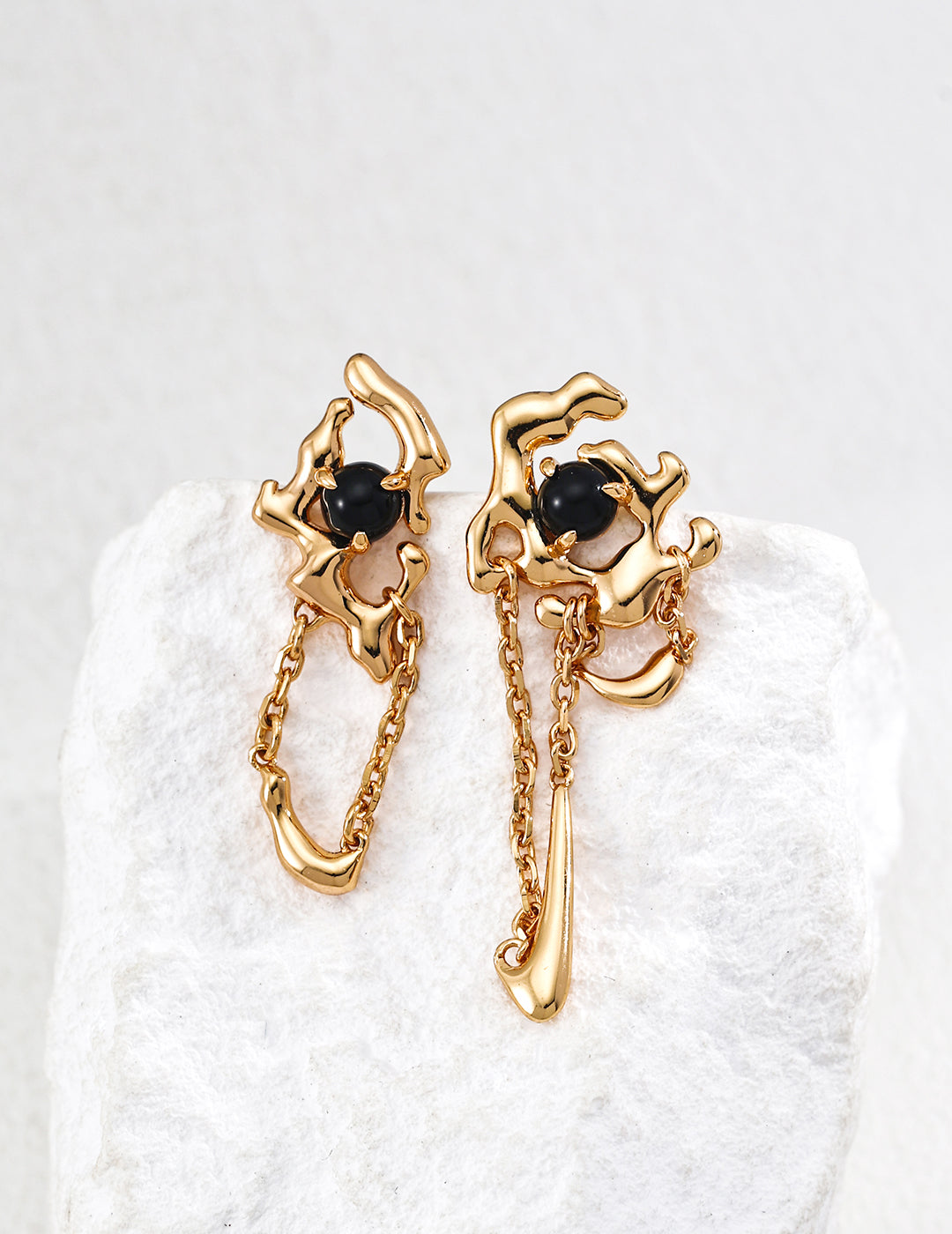Dare To Sparkle - Avant-garde asymmetric gold molten lava earrings featuring natural black onyx beads with flowing liquid chain tassels