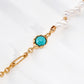 Gold bracelet with a turquoise stone on a white background