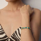 A model wearing vibrant artistic open cuff bangle with multi-color hand-painted enamel abstract oil painting motifs in high polished gold finish