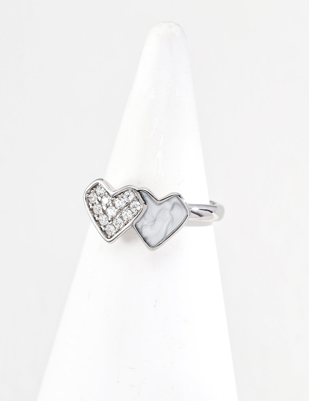 Silver ring with heart-shaped designs on a white background