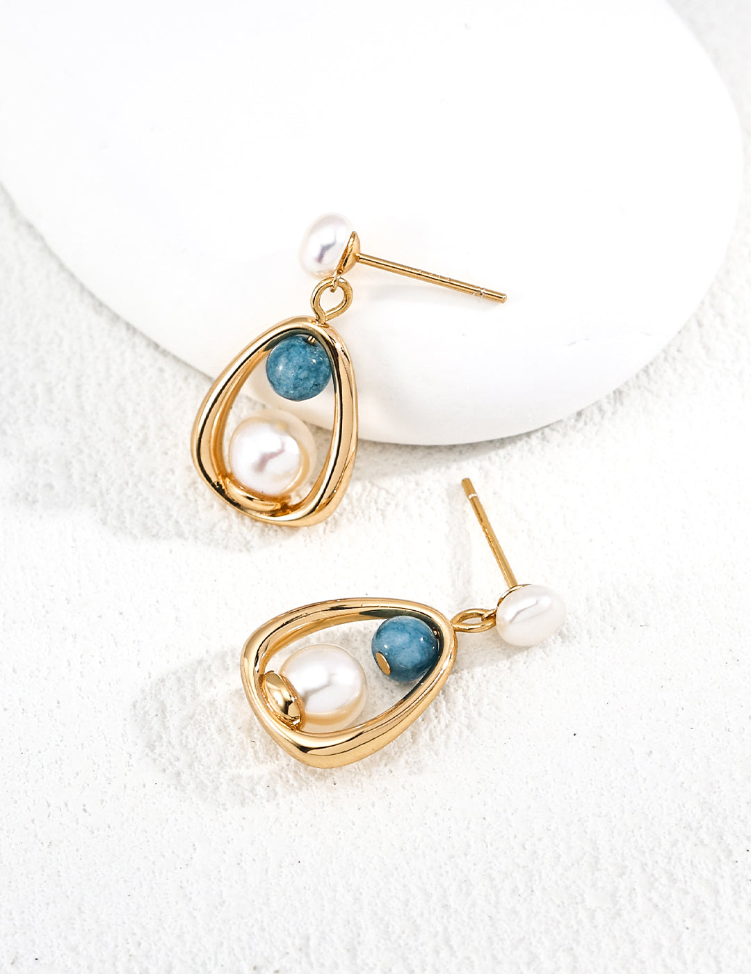 Dare To Sparkle - Vintage lantern-inspired gold earrings featuring a natural white pearl candle motif and a dangling blue gemstone bead