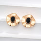Dare To Sparkle - Regal vintage gold statement earrings featuring large wavy metallic discs centering a polished natural black onyx stone