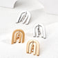 Dare To Sparkle - Contemporary CNC precision cut layered arch stud earrings with a central dangling cubic zirconia stone in silver and gold finishes