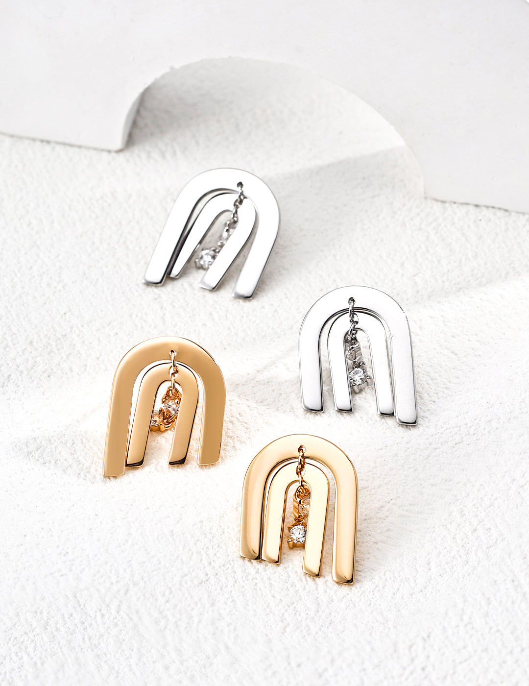 Dare To Sparkle - Contemporary CNC precision cut layered arch stud earrings with a central dangling cubic zirconia stone in silver and gold finishes