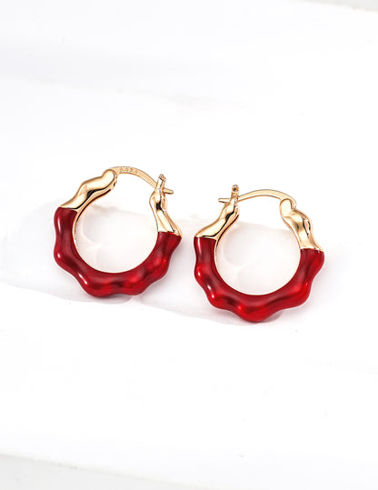 Vintage gold plated wave hoop earrings featuring half fluid metal and half glossy burgundy red enamel finishes