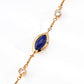 Close-up look of the elegant vintage gold chain bracelet featuring a central marquise natural deep blue lapis lazuli stone and bezel-set round cz crystals