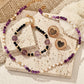 Set of beaded jewelry with heart-shaped charms on a textured surface