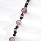 Necklace with purple and dark blue beads on a white background