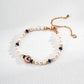 Dare To Sparkle - Luminous natural freshwater pearl strand bracelet with dark blue lapis lazuli accents and a central gold celestial crescent moon charm with a cz crystal