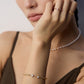 A model wearing contemporary minimalist open-band cuff bracelet and matching ring set in gold finishes featuring radiant prong-set cz gems flanking both open ends