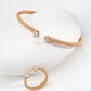 Dare To Sparkle - Contemporary minimalist open-band cuff bracelet and matching ring set in gold finishes featuring radiant prong-set cz gems flanking both open ends