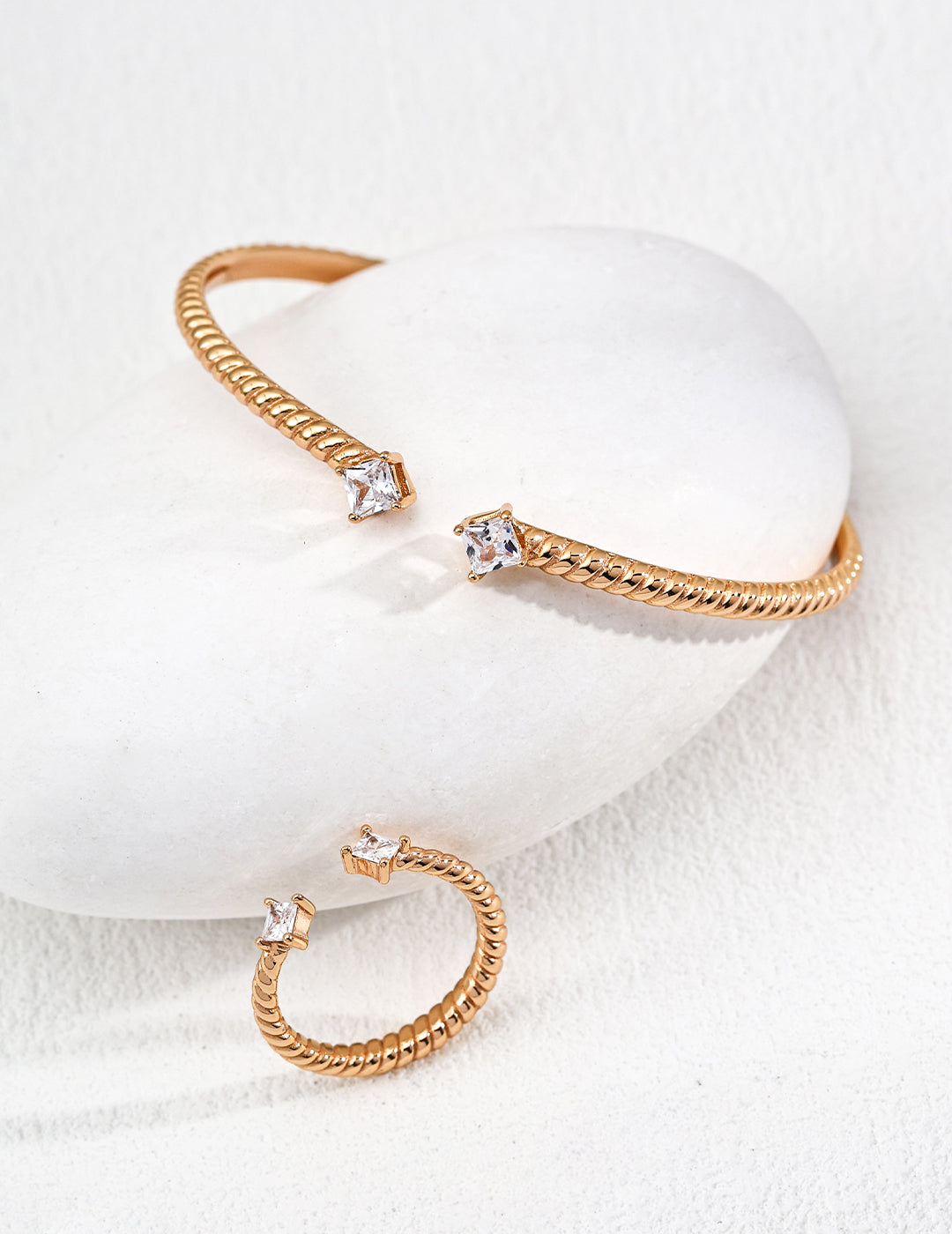 Dare To Sparkle - Contemporary minimalist open-band cuff bracelet and matching ring set in gold finishes featuring radiant prong-set cz gems flanking both open ends