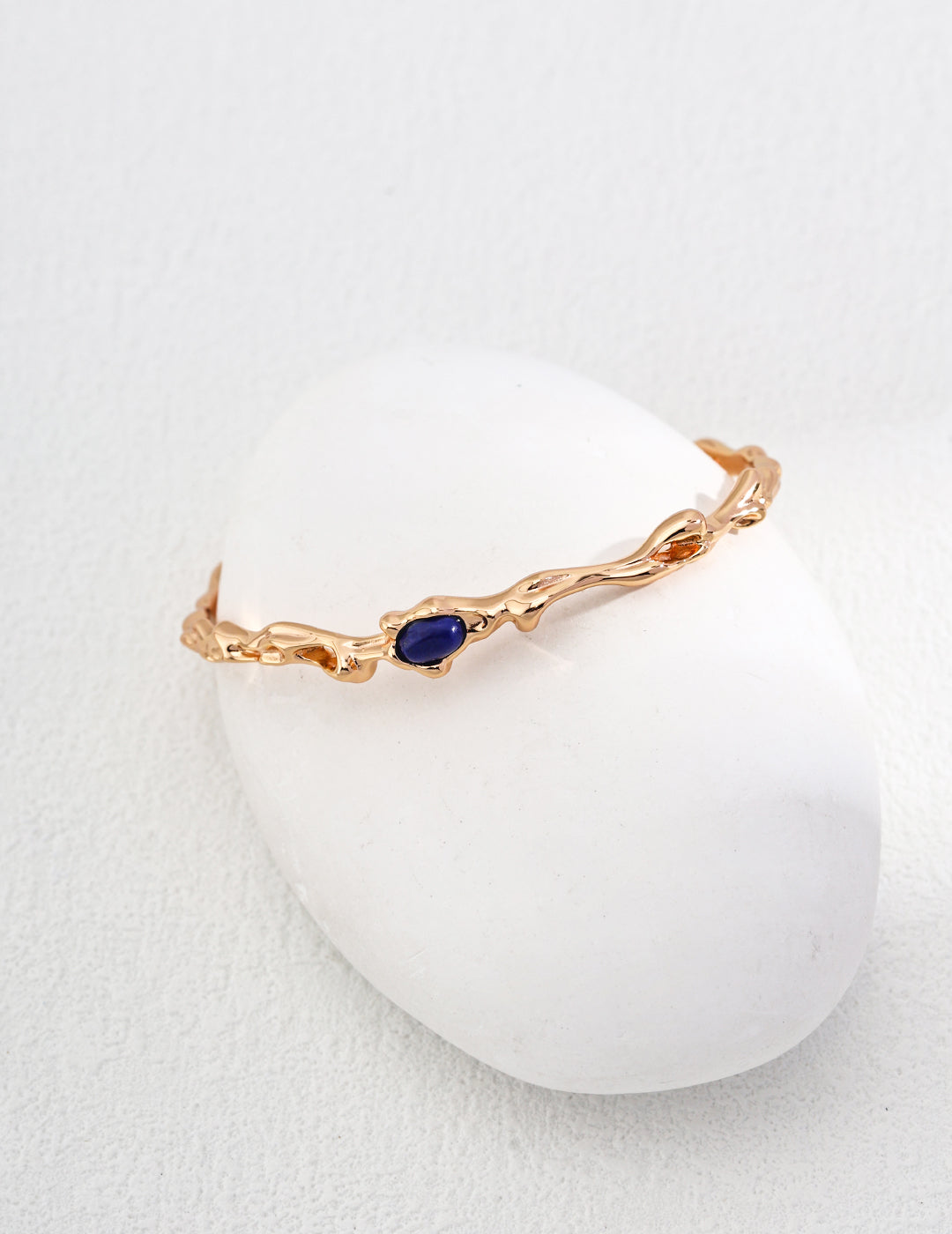 Dare To Sparkle - Antique style statement open cuff bracelet featuring an organic fluid molten gold texture centering a smooth oval natural blue lapis lazuli stone