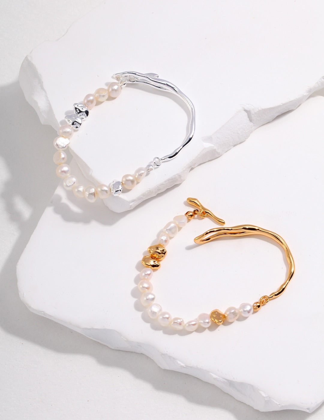 Dare To Sparkle - Avant-garde half-cuff half-strand bracelets featuring organic liquid molten silver and gold metals, a custom fluid OT clasp, and irregular stone-shaped pearls