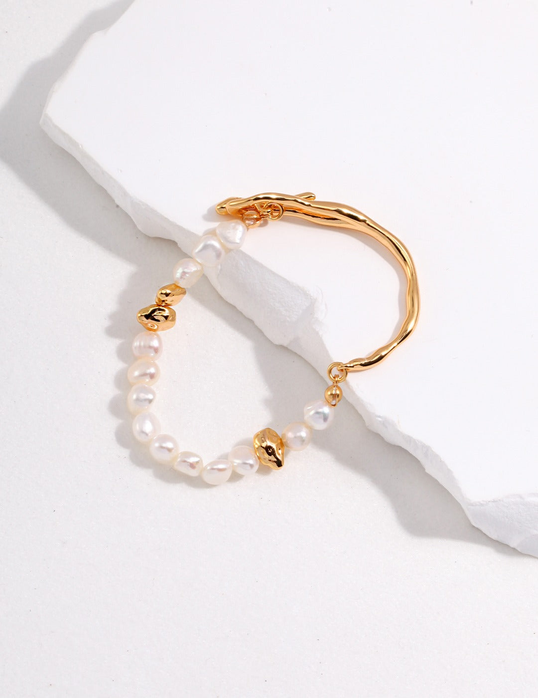 Dare To Sparkle - Avant-garde half-cuff half-strand bracelets featuring organic liquid molten gold metals, a custom fluid OT clasp, and irregular stone-shaped pearls