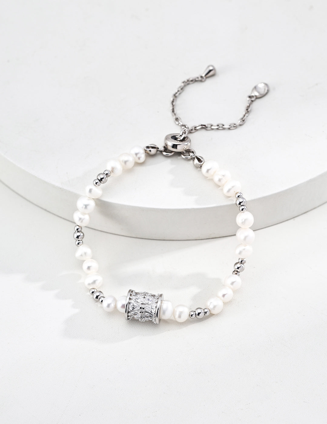 Dare To Sparkle - Luxury natural freshwater pearl strand bracelets featuring a central spinning cylinder charm paved with sparkling cz crystals in silver