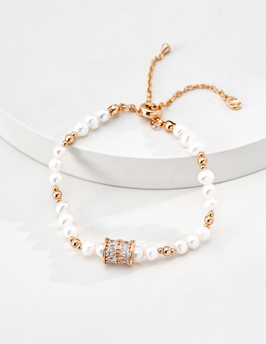 Dare To Sparkle - Luxury natural freshwater pearl strand bracelets featuring a central spinning cylinder charm paved with sparkling cz crystals in gold
