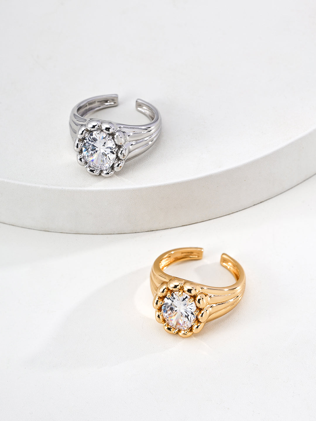 Dare To Sparkle - Luxury high-jewelry style open adjustable rings featuring a large brilliant central cz stone enclosed by a sculptural bubble bezel in silver and gold