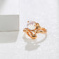 Gold ring with a central gemstone on a white background