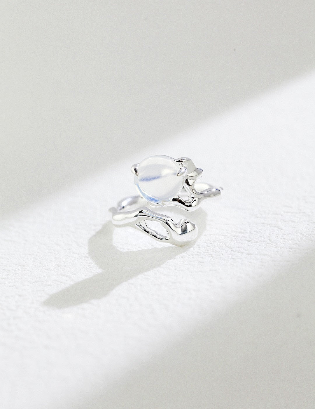 Silver ring with a large gemstone on a white background