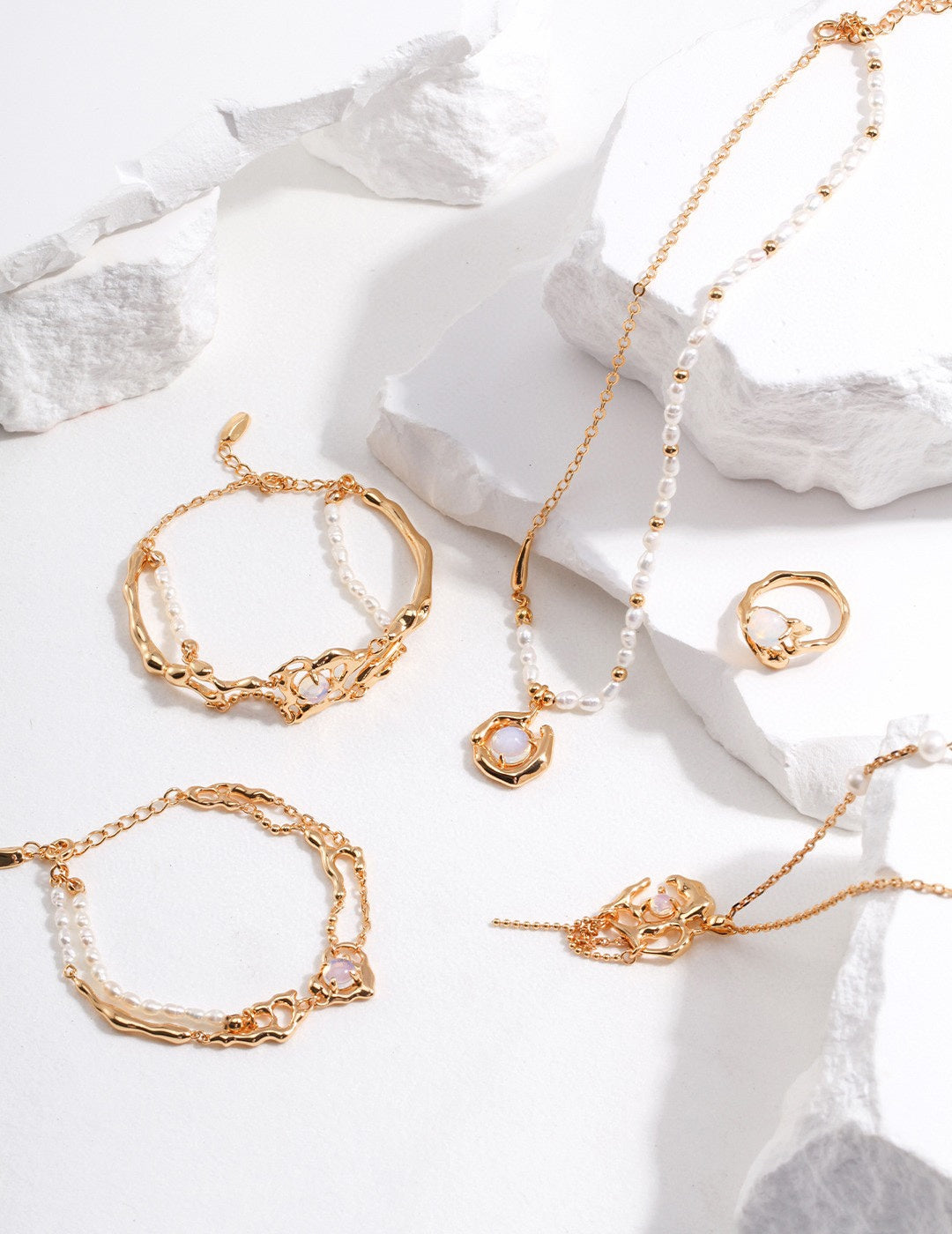 Dare To Sparkle - Avant-garde jewelry set featuring semi-translucent natural opals with shifting blue halos wrapped in fluid molten metal vines in silver and gold