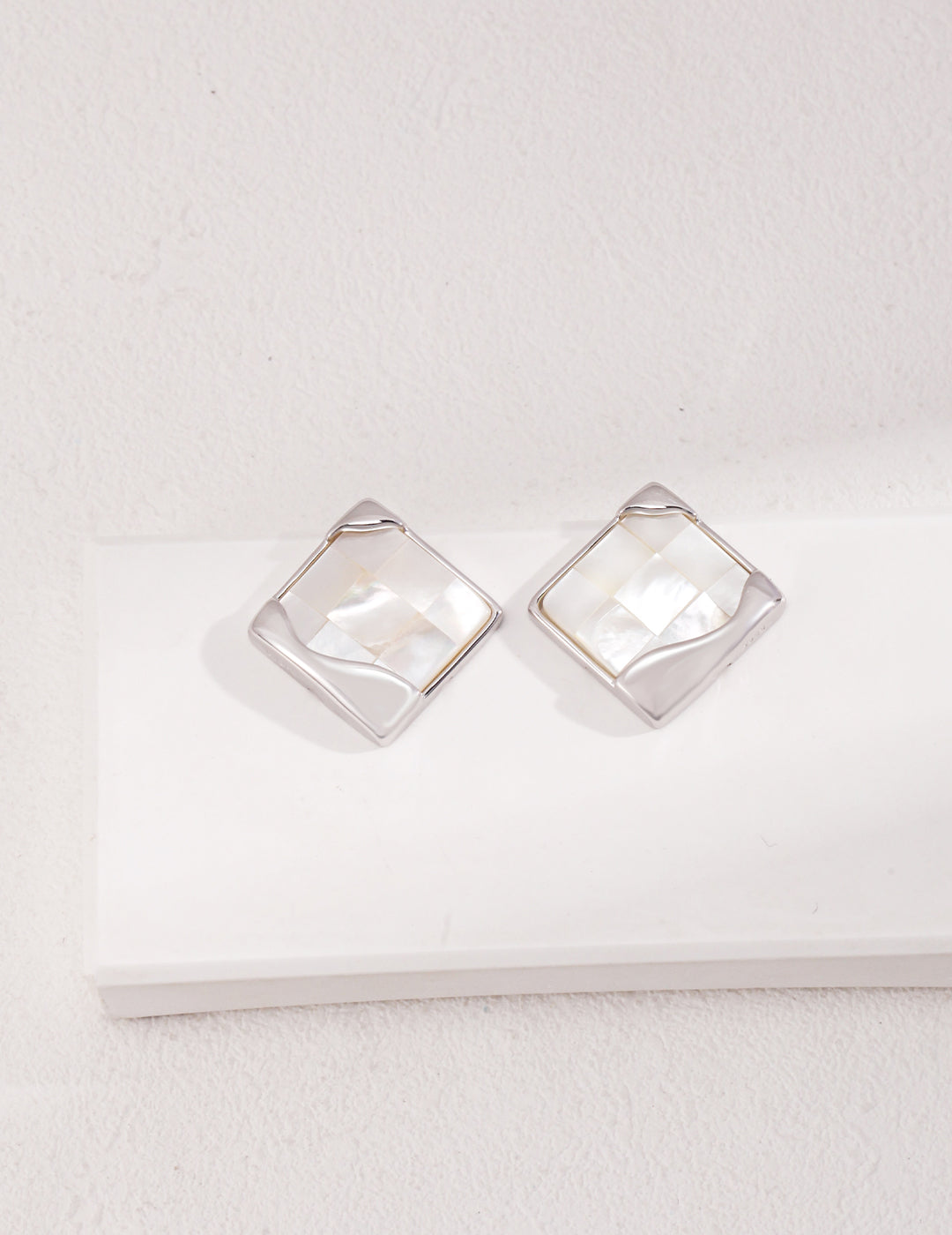 Dare To Sparkle - Statement square stud earrings with a handmade mother-of-pearl mosaic checkerboard pattern and an asymmetric fluid molten metal corner in silver