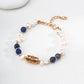 Dare To Sparkle - Elegant 18k gold plated strand bracelet featuring deep blue natural aventurine stones and a central sculptural four-leaf clover charm with a sparkling cz crystal