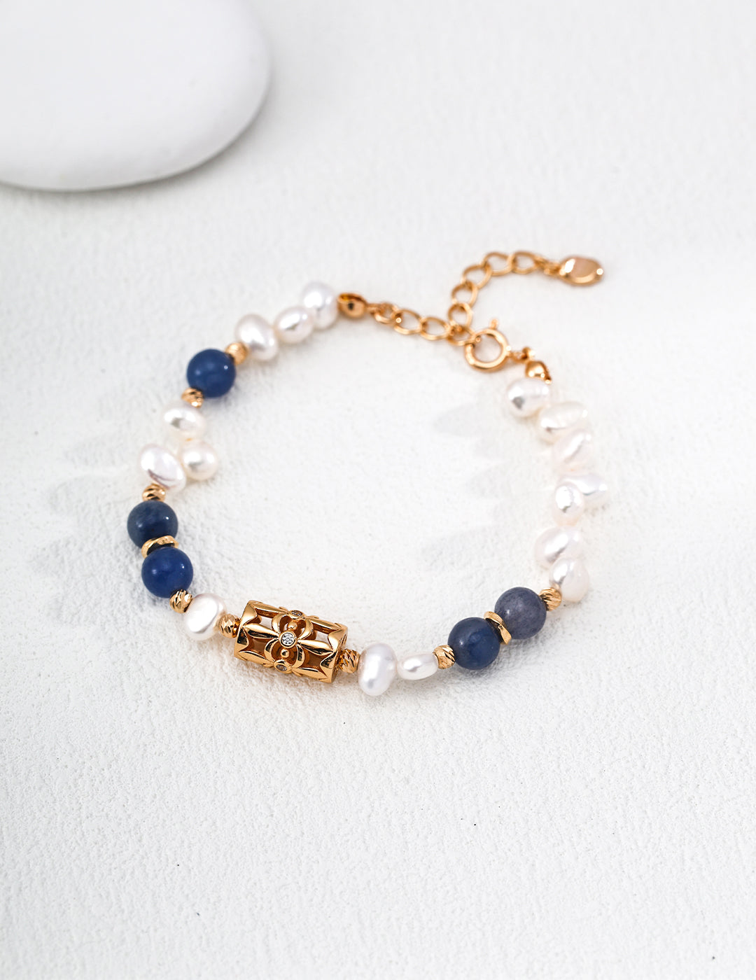 Dare To Sparkle - Elegant 18k gold plated strand bracelet featuring deep blue natural aventurine stones and a central sculptural four-leaf clover charm with a sparkling cz crystal