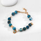 Dare To Sparkle - Elegant 18k gold plated strand bracelet featuring deep blue natural azurite turquoise minerals, lustrous freshwater pearls, and a central star medallion