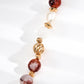 Bracelet with multicolored beads and gold accents on a white background