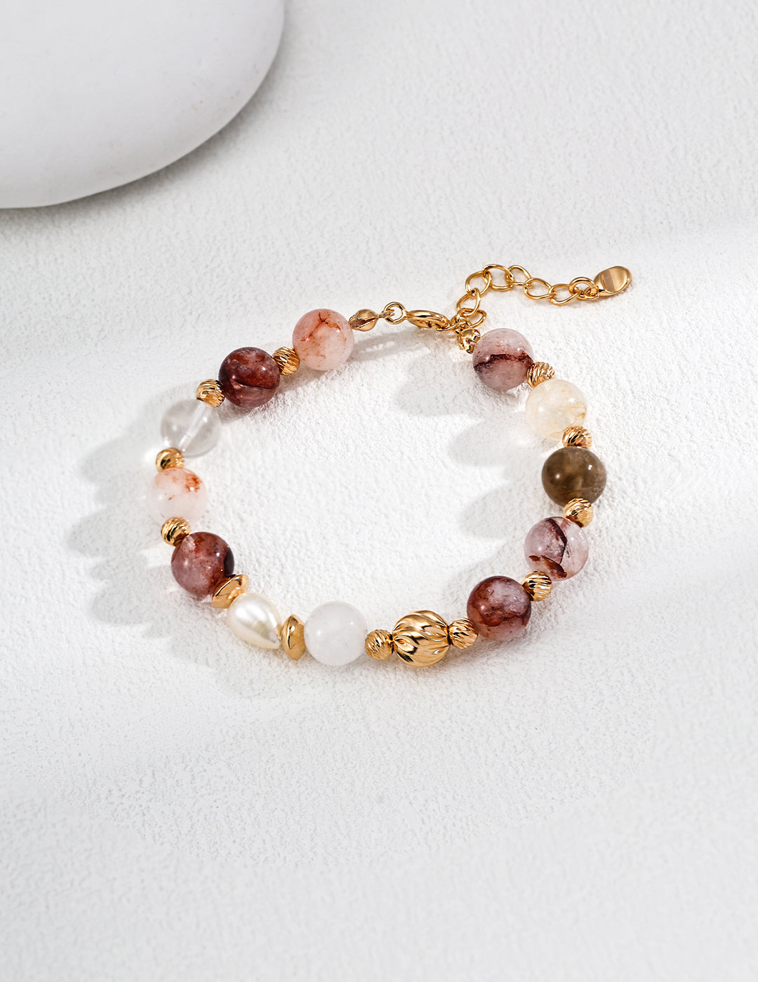 Dare To Sparkle - Luxury strand bracelet featuring rich red hematoid quartz beads, clear crystals, glowing white pearls, and a central textured twisted gold ball