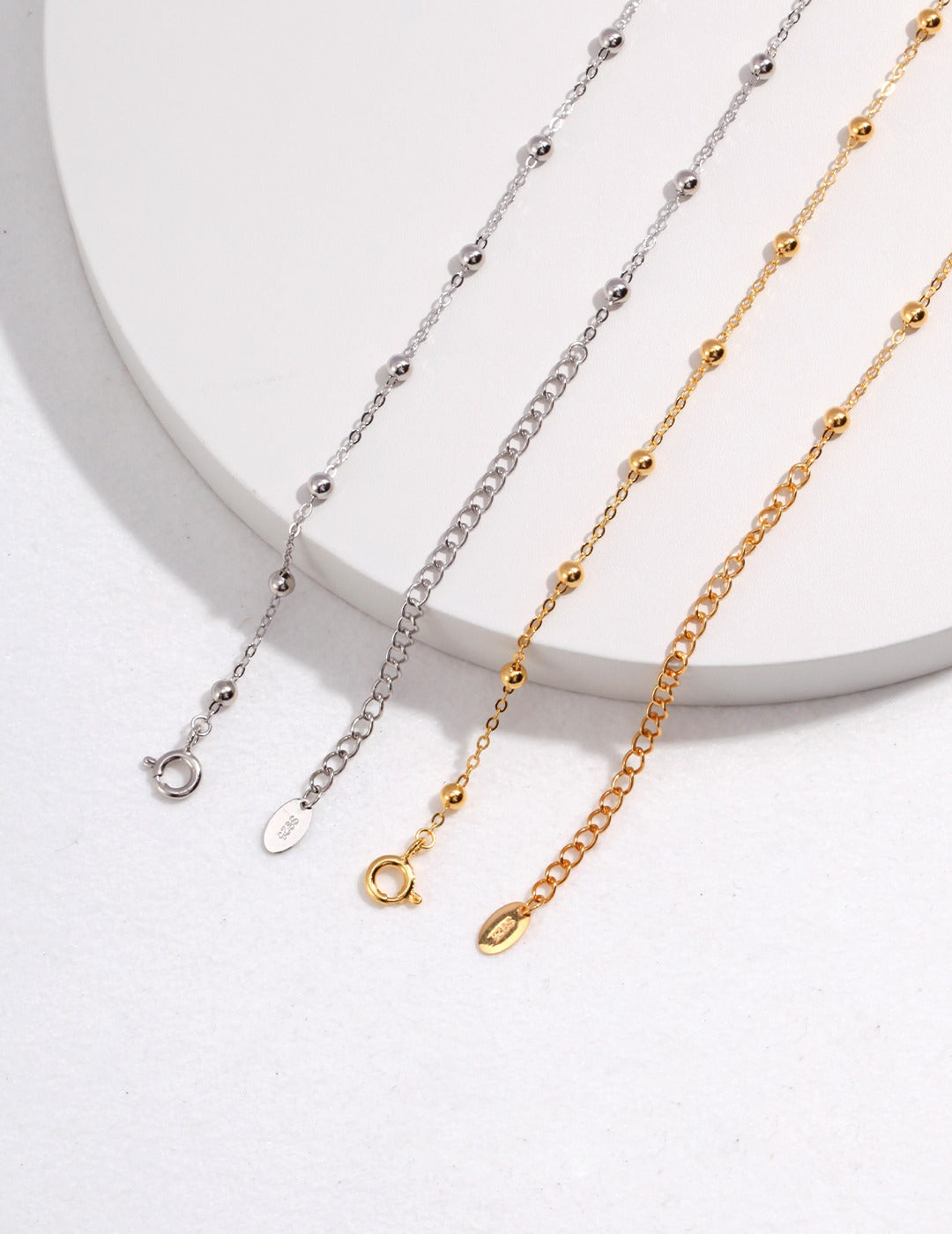 Dare To Sparkle - Versatile high-polished sterling silver faceted bead chains shown with and without a detachable starburst engraved round coin pendant in gold and silver