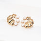 Gold earrings with pearl accents on a white background