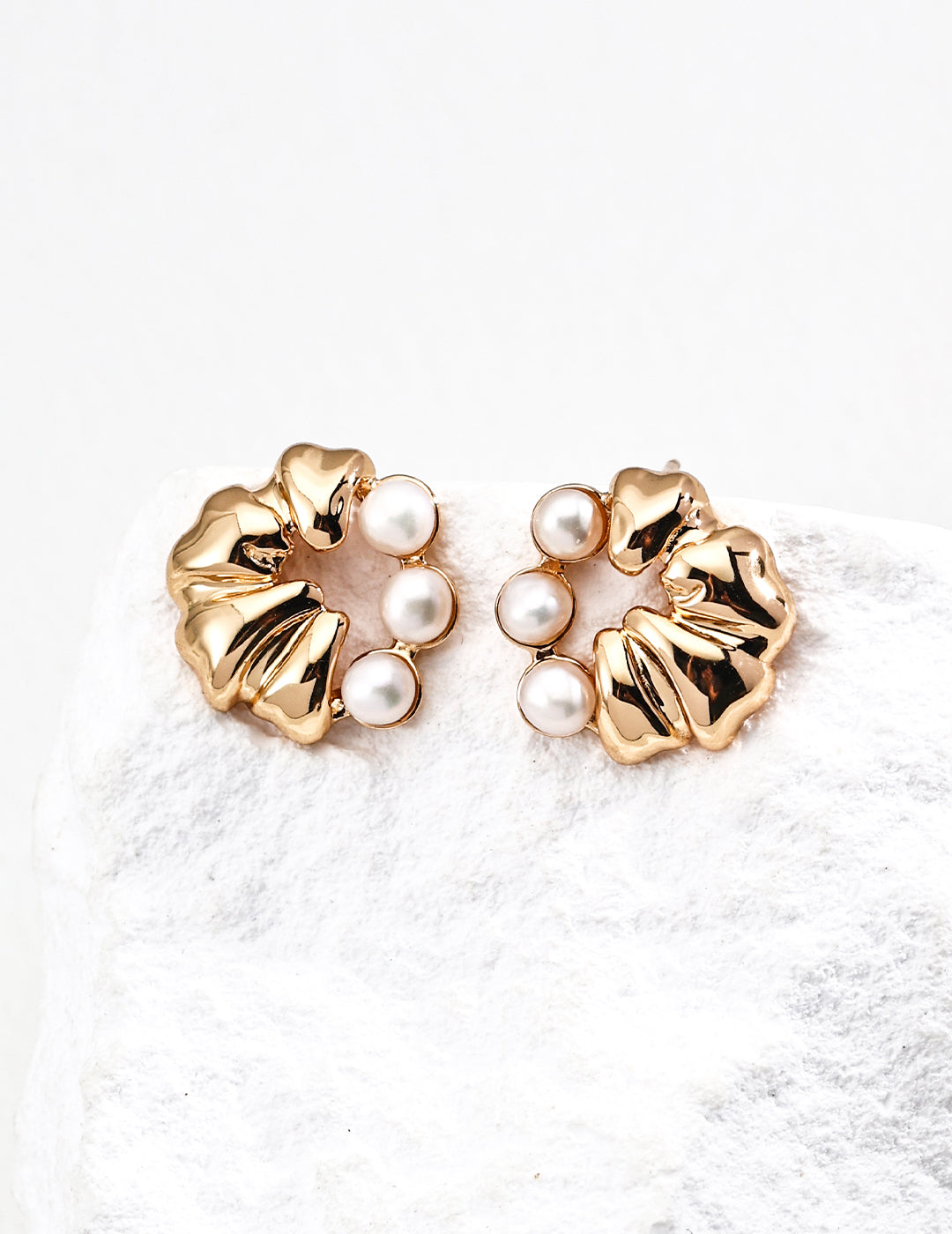 Dare To Sparkle - Luxury round statement stud earrings featuring a half split design of sculptural pleated 18k gold and a row of embedded white shell pearls