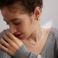 A model wearing 3D Heart Bow Pearl Drop Earrings in gold plated sterling silver romantic aesthetic