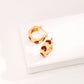 Dare To Sparkle - Avant-garde geometric heart stud earrings featuring asymmetrical cutout fluid metallic loops with high-polished black and white enamel inlay