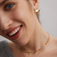 A model wearing an avant-garde geometric choker necklace featuring a rare red and white tartan grid pattern natural agate pendant held by a sparkling micro-pavé cz bail