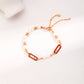 Dare To Sparkle - Luxury 18k gold plated bracelet featuring rice freshwater pearls, crimson red enamel oblong links, and an adjustable chain slider closure