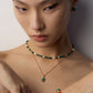 A model wearing an organic molten gold framed natural malachite pendant necklace