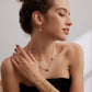 A model wearing French style minimalist jewelry set featuring premium silver prong-set radiant square cubic zirconia pendant necklace, open ring, and stud earrings