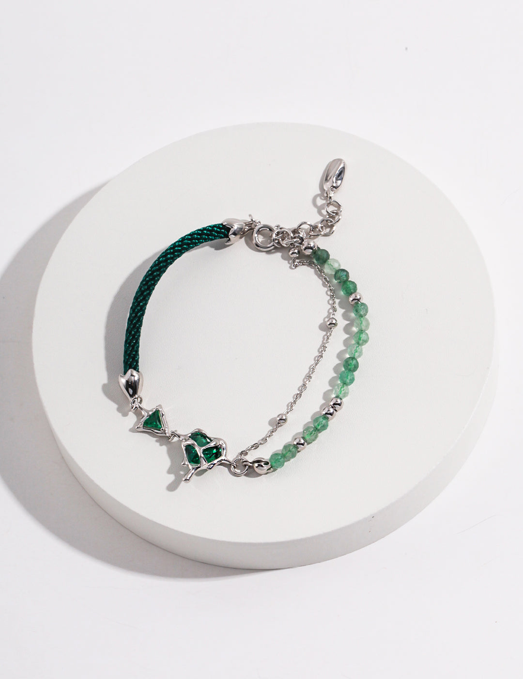 Dare To Sparkle - Avant-garde asymmetric split-design bracelet featuring faceted green strawberry quartz beads, fluid molten silver hearts, and a deep green woven silk cord