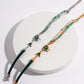 Dare To Sparkle - Avant-garde asymmetric split-design bracelet featuring faceted green strawberry quartz beads, fluid molten silver and gold hearts, and a deep green woven silk cord