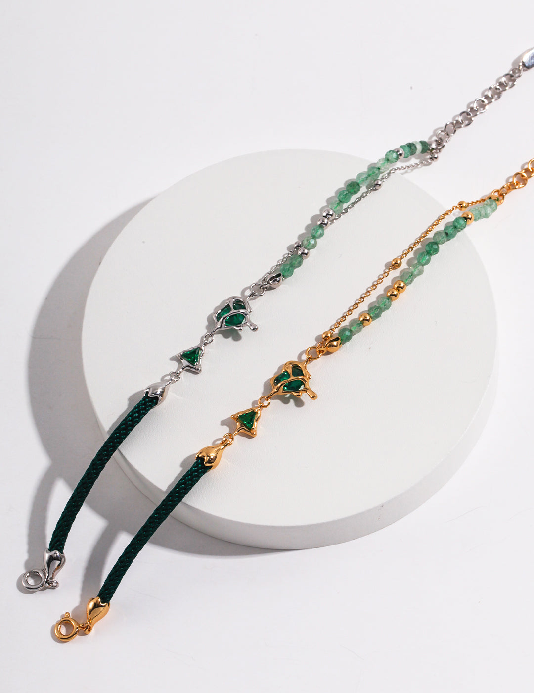 Dare To Sparkle - Avant-garde asymmetric split-design bracelet featuring faceted green strawberry quartz beads, fluid molten silver and gold hearts, and a deep green woven silk cord