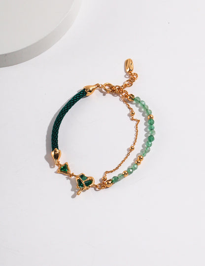 Dare To Sparkle - Avant-garde asymmetric split-design bracelet featuring faceted green strawberry quartz beads, fluid molten gold hearts, and a deep green woven silk cord