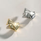 Dare To Sparkle - Avant-garde non-pierced ear cuff showing a wide high-polished fluid molten metal crumpled sculptural silhouette in sterling silver and 18k gold plating