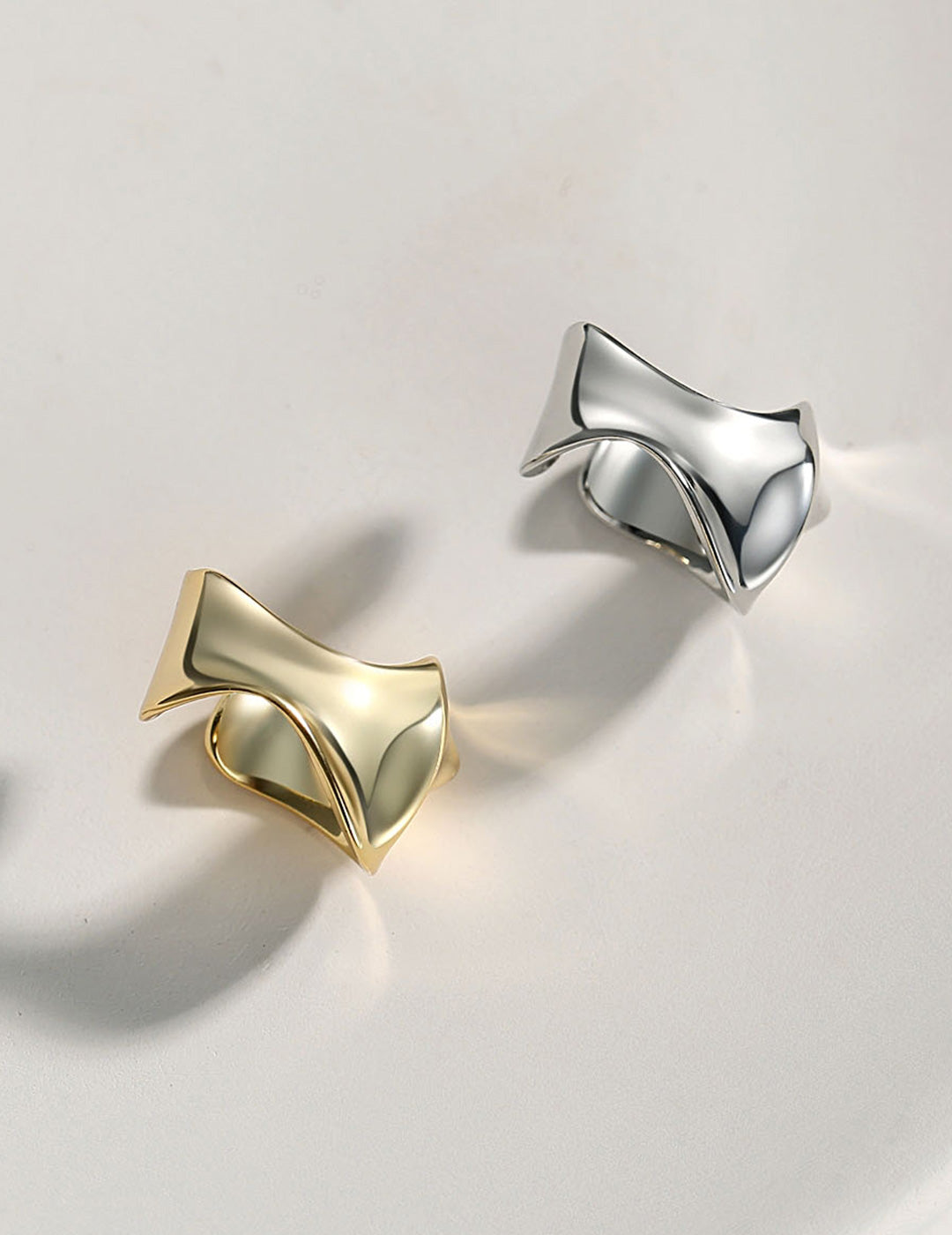 Dare To Sparkle - Avant-garde non-pierced ear cuff showing a wide high-polished fluid molten metal crumpled sculptural silhouette in sterling silver and 18k gold plating