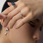 A model wearing contemporary minimalist open-band cuff ring set in silver finishes featuring radiant prong-set cz gems flanking both open ends