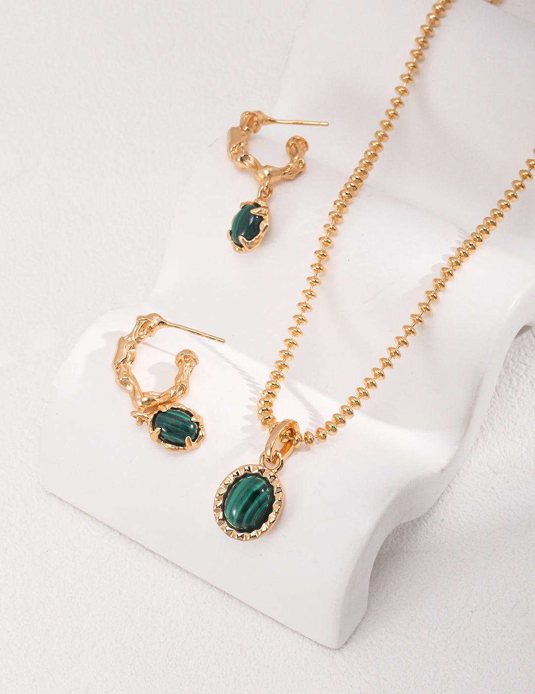 Dare To Sparkle - Resort style jewelry set displaying an organic molten gold framed natural malachite pendant necklace and matching malachite c-hoop drop earrings