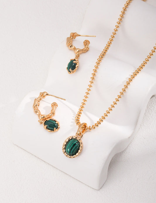 Dare To Sparkle - Resort style jewelry set displaying an organic molten gold framed natural malachite pendant necklace and matching malachite c-hoop drop earrings