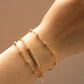 Close-up of a wrist wearing a gold custom name bracelet